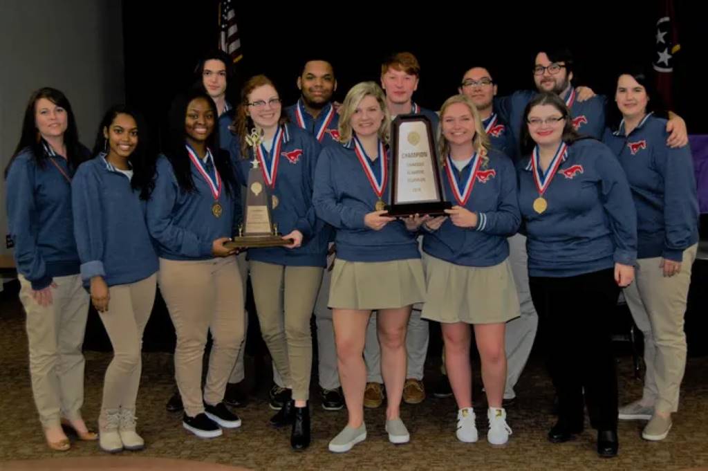 High school students celebrating Academic Decathlon victory