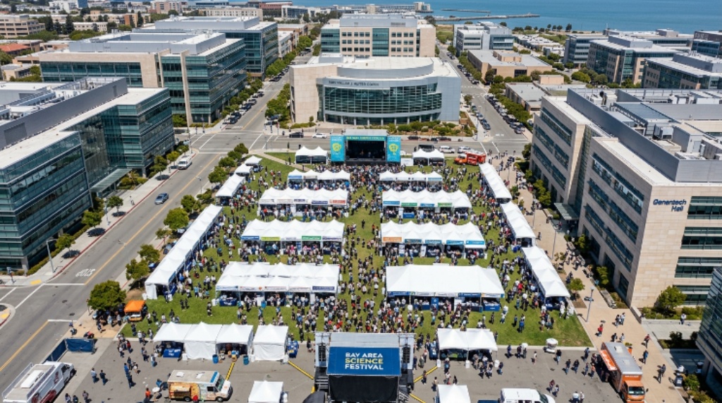 Aerial view of the Koret Quad at UCSF Mission Bay filled with exhibitor booths and attendees at the Bay Area Science Festival
